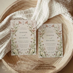 May include: Two wedding invitations with floral designs. The invitations are for Harper and Michael's wedding on Saturday, October 28th at 3 o'clock in the afternoon at The Ritz Carlton in Miami, Florida.