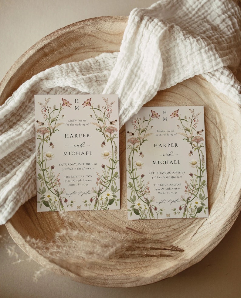 May include: Two wedding invitations with floral designs. The invitations are for Harper and Michael's wedding on Saturday, October 28th at 3 o'clock in the afternoon at The Ritz Carlton in Miami, Florida.