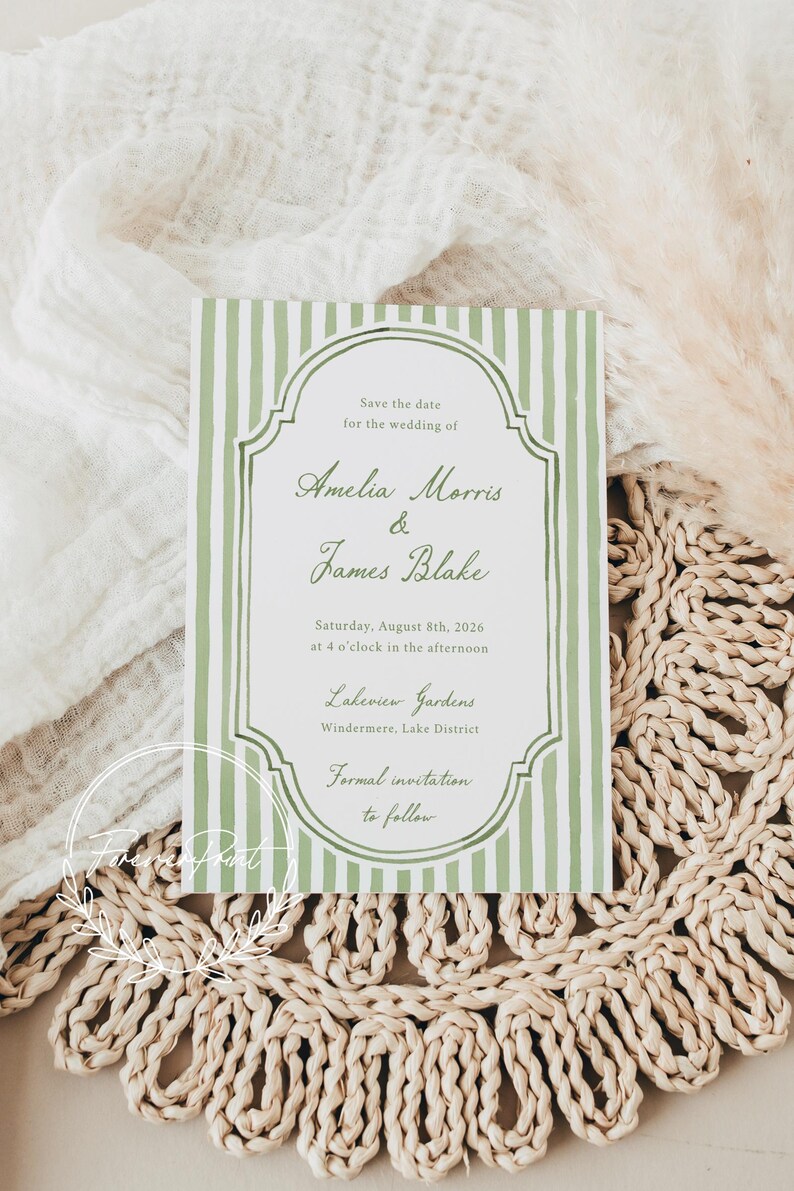 May include: A wedding invitation with a green and white striped design. The text reads "Save the date for the wedding of Amelia Morris & James Blake" with the date, time, and location. The invitation is on a woven placemat.