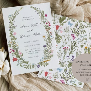 May include: Wedding invitation with a floral wreath border. The invitation is for the wedding of Maeve Hill and Bixen Neelle, on Saturday, July 15th at 3 o'clock in the afternoon at The Ritz Carlton, 1700 SW 27th Avenue, Miami, FL 33155. Reception to follow.