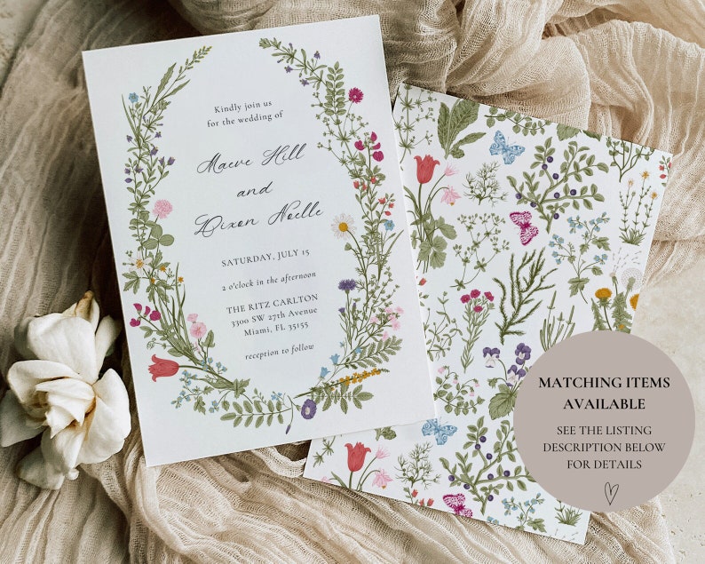 May include: Wedding invitation with a floral wreath border. The invitation is for the wedding of Maeve Hill and Bixen Neelle, on Saturday, July 15th at 3 o'clock in the afternoon at The Ritz Carlton, 1700 SW 27th Avenue, Miami, FL 33155. Reception to follow.