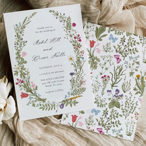 May include: Wedding invitation with floral wreath and matching patterned card. The invitation includes the names Mabel Hill and Bixen Neelle, with the date Saturday, July 14, and the Ritz Carlton address in Miami, FL.