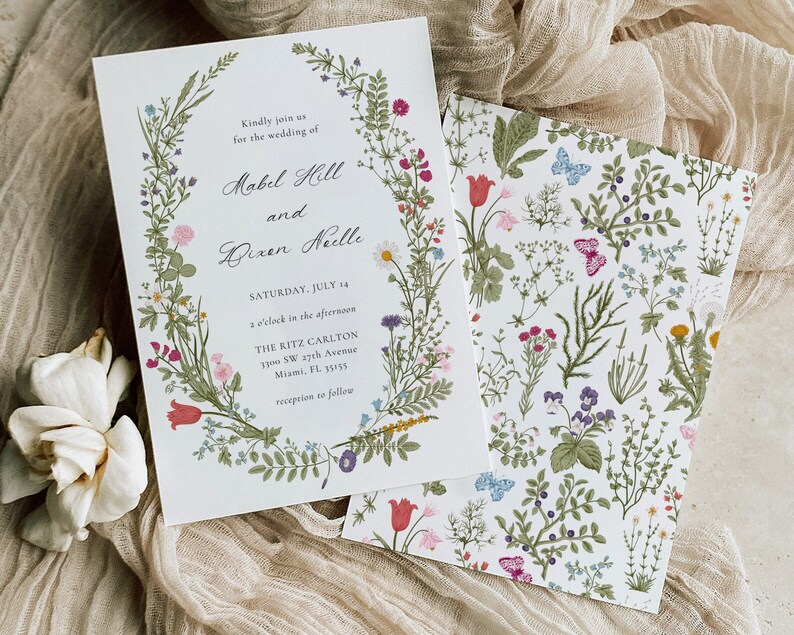 May include: Wedding invitation with floral wreath and matching patterned card. The invitation includes the names Mabel Hill and Bixen Neelle, with the date Saturday, July 14, and the Ritz Carlton address in Miami, FL.