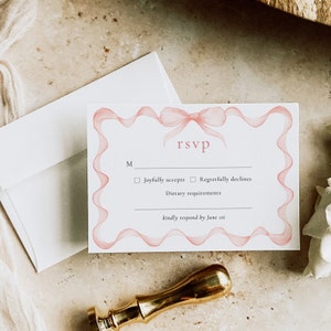 May include: RSVP card with a pink ribbon design. The card has a checkbox for "Joyfully accepts" and "Regretfully declines". It also includes a space for "Dietary requirements" and a note to "kindly respond by June 1st."
