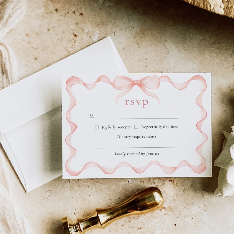 May include: RSVP card with a pink ribbon design. The card has a checkbox for "Joyfully accepts" and "Regretfully declines". It also includes a space for "Dietary requirements" and a note to "kindly respond by June 1st."