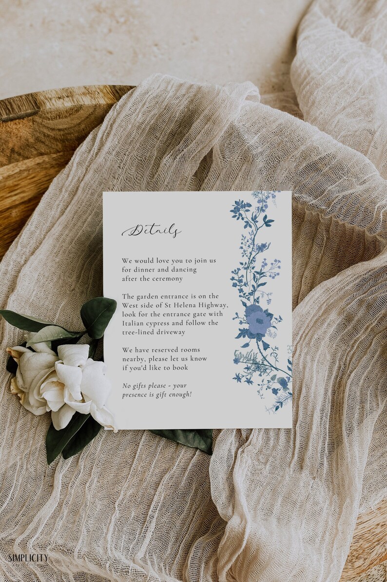May include: A white card with blue floral illustrations and the text "Details" in cursive. The card includes information about a wedding reception, including the location, directions, and a note about reserved rooms. The text reads: "We would love you to join us for dinner and dancing after the ceremony. The garden entrance is on the West side of St Helena Highway, look for the entrance gate with Italian cypress and follow the tree-lined driveway. We have reserved rooms nearby, please let us know if you'd like to book. No gifts please - your presence is gift enough!"