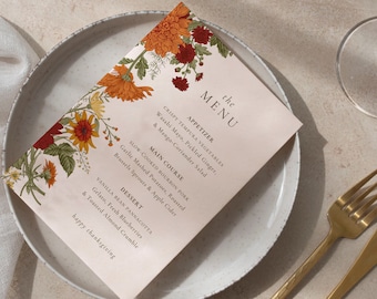 May include: A Thanksgiving menu with a floral design featuring red, orange, and yellow flowers. The menu includes appetizers, main course, and dessert options. The text reads "the MENU", "APPETIZER", "CRISPY TEMPURA VEGETABLES", "Wasabi Mayo, Pickled Ginger, & Mango-Coriander Salad", "MAIN COURSE", "SLOW-COOKED BOURBON PORK", "Garlic Mashed Potatoes, Roasted Brussels Sprouts & Apple Cider", "DESSERT", "VANILLA BEAN PANNACOTTA", "Gelato, Fresh Blueberries & Toasted Almond Crumble", and "happy thanksgiving".