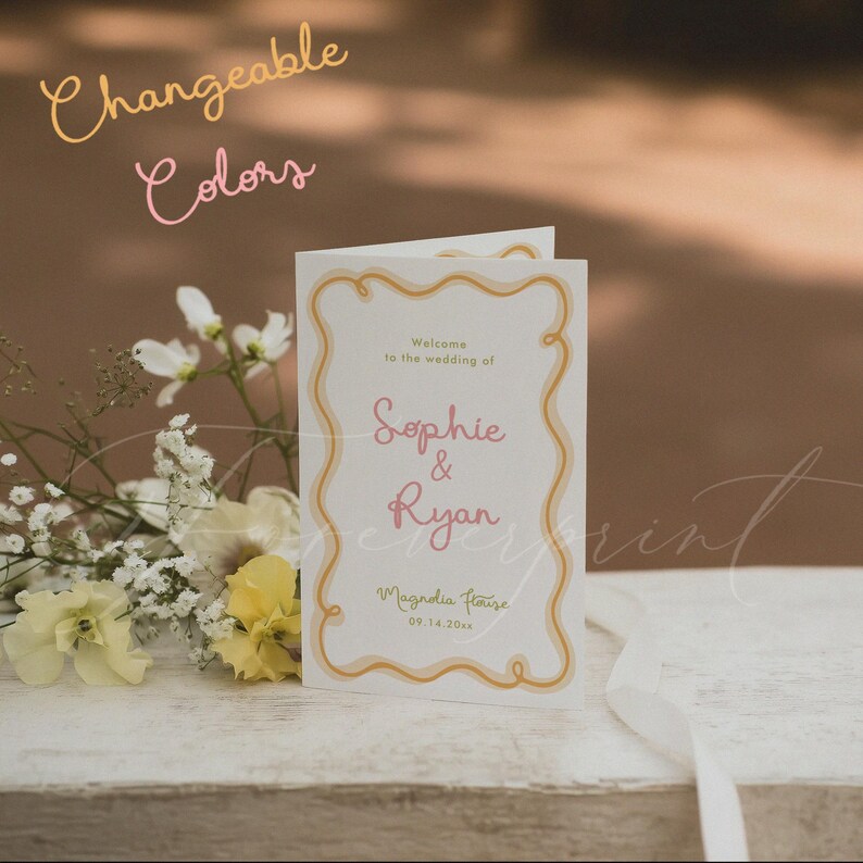 May include: A folded white wedding programme card featuring a wavy gold border, pink text reading Sophie & Ryan, and the text Welcome to the wedding of, Magnolia House, and 09.14.20xx. The text Changeable Colors appears in the upper left corner.