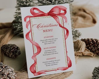 May include: A Christmas menu card with a red bow and ribbon design. The card features the word "Christmas Menu" in elegant script, with a gold border. The menu lists starters, main dishes, and desserts, including Christmas turkey and chocolate orange torte.