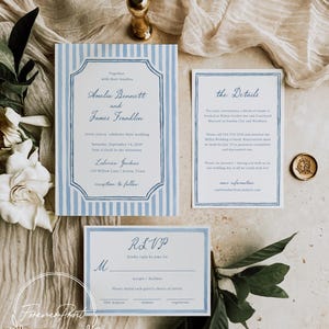 May include: Wedding invitation suite featuring a main invitation with blue and white stripes, a details card, and an RSVP card. The suite includes text in a classic font, a gold wax seal, and floral accents. The invitation is for Amelia Bennett and James Franklin.