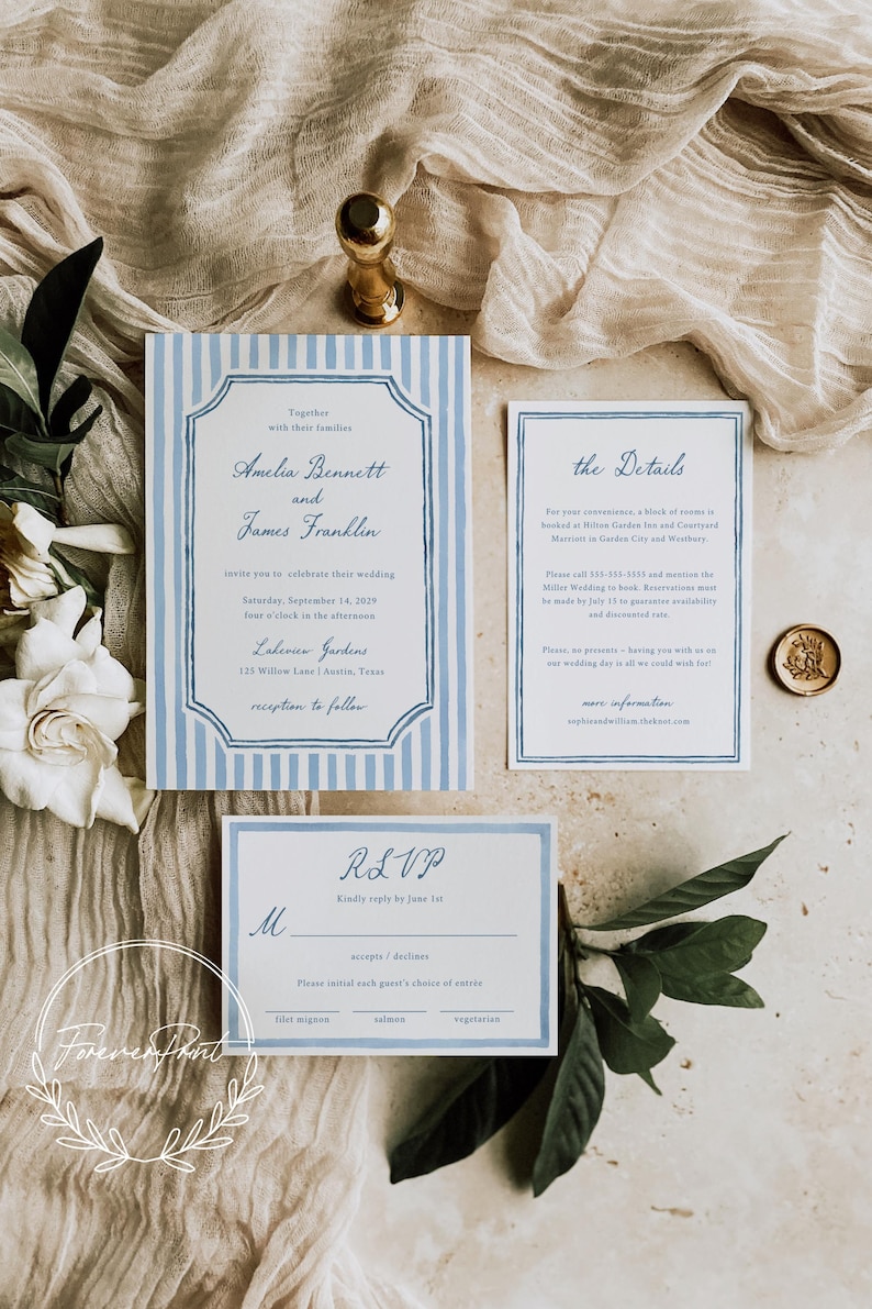 May include: Wedding invitation suite featuring a main invitation with blue and white stripes, a details card, and an RSVP card. The suite includes text in a classic font, a gold wax seal, and floral accents. The invitation is for Amelia Bennett and James Franklin.