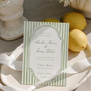 May include: A formal wedding invitation with a green and white striped design. The text reads "Save the date for the wedding of Amelia Morris & James Blake", with the date, time, and location. Two lemons are visible.
