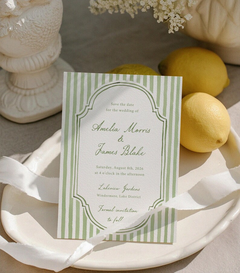 May include: A formal wedding invitation with a green and white striped design. The text reads "Save the date for the wedding of Amelia Morris & James Blake", with the date, time, and location. Two lemons are visible.
