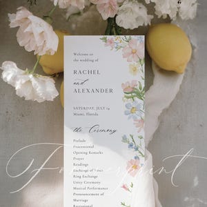 May include: A wedding program with floral accents, featuring the names Rachel and Alexander, and the date July 14 in Miami, Florida. The program includes the ceremony's order, with a soft, elegant design and a white background.
