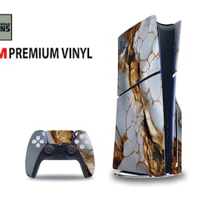 May include: A PlayStation 5 console and controller skin set. The skins feature a white and gold marble design. The console is upright, and the controller is in front of it. The text "WUNDERBAR SKINS" and "3M PREMIUM VINYL" are in the upper left corner.