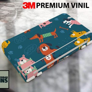 May include: A teal-colored electronic device skin featuring a playful dog pattern. The design includes various cartoon dogs, paw prints, and speech bubbles with the words "Dog" and "Woof". The text "3M Premium Vinil" is at the top.