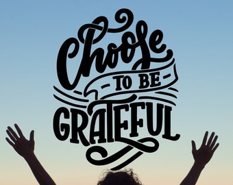 May include: Silhouette of a person with arms raised against a colorful sunset sky. The text "Choose to be Grateful" is written in a stylized font above the person. Below the person, the text "101 Days of Gratitude" and "Dr. Charles M. McCoin" are written in a smaller font.