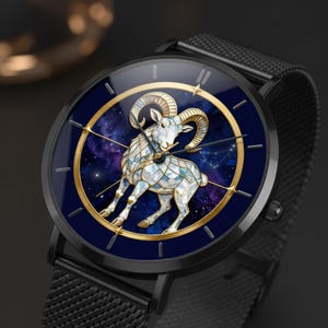 May include: A black wristwatch featuring a circular face with a deep blue galaxy background. The centre displays a stylised ram figure composed of iridescent, mosaic-like segments. A thin gold circular frame surrounds the ram, and the watch has a black mesh band.