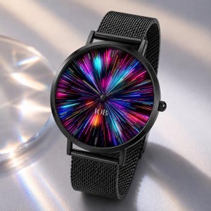 May include: A black wristwatch with a mesh metal band and a round case. The watch face features a vibrant, multi-colored radial light burst pattern in shades of blue, purple, and pink, with the text IOB printed in white near the center.