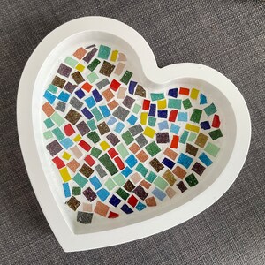 May include: White heart-shaped ceramic dish with a mosaic of colourful tiles in shades of blue, green, red, yellow, and white.