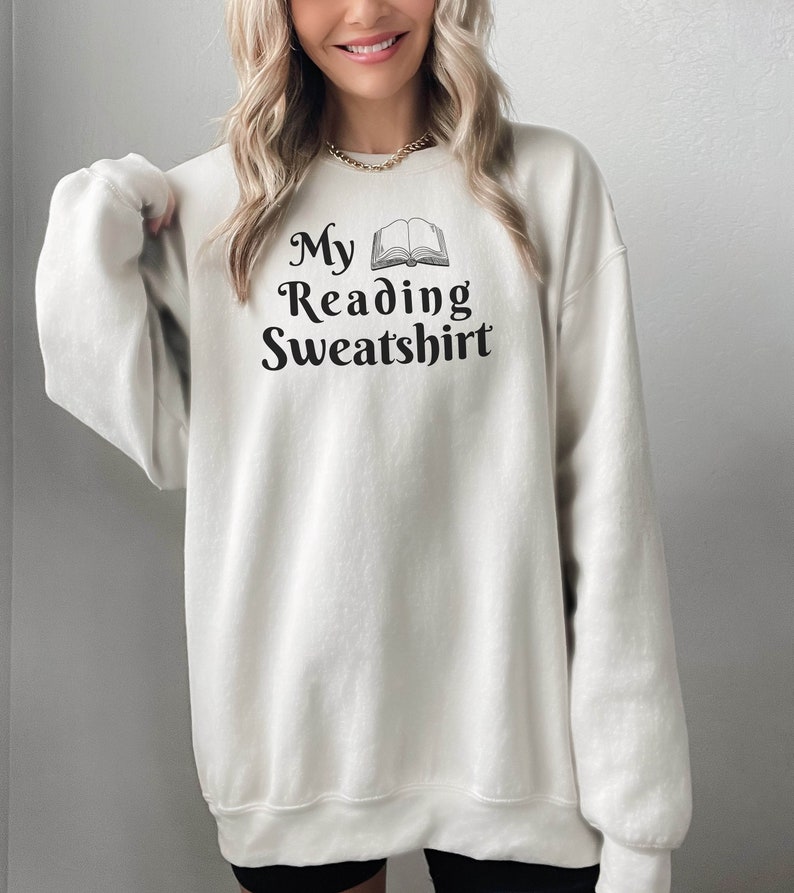May include: A white sweatshirt with the text "My Reading Sweatshirt" and an illustration of an open book.