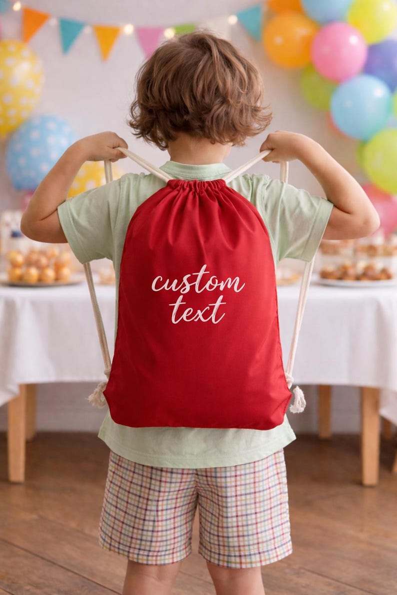 A young child wearing a red backpack with the text "custom text" printed on it, standing in front of a table with colorful balloons.