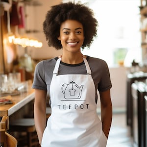 a woman wearing an apron and smiling at the camera