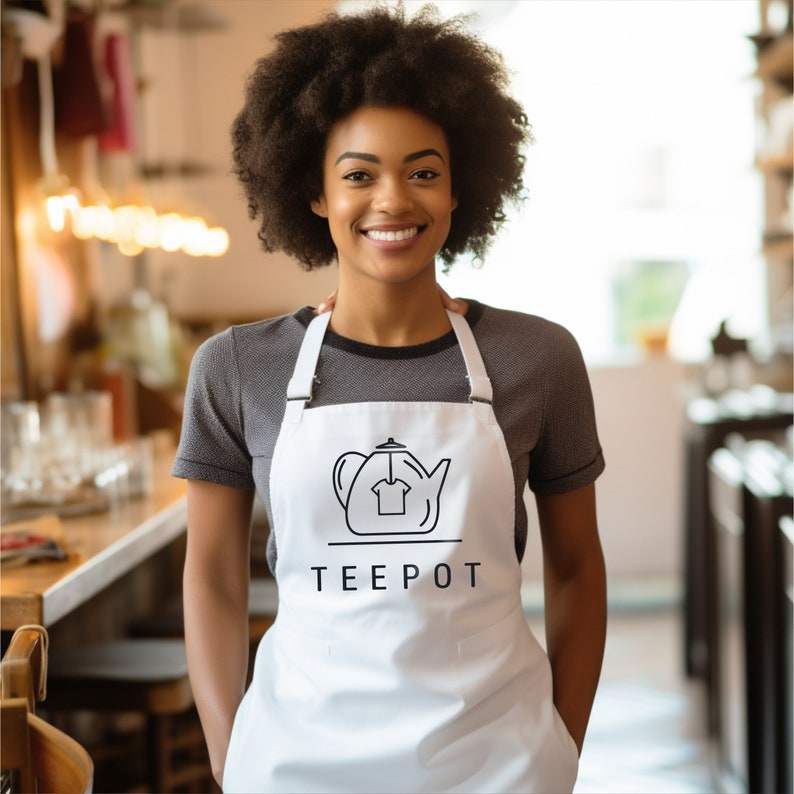 a woman wearing an apron and smiling at the camera