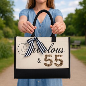 A woman holding a large tote bag with the text "Fantastic & 55" printed on it.