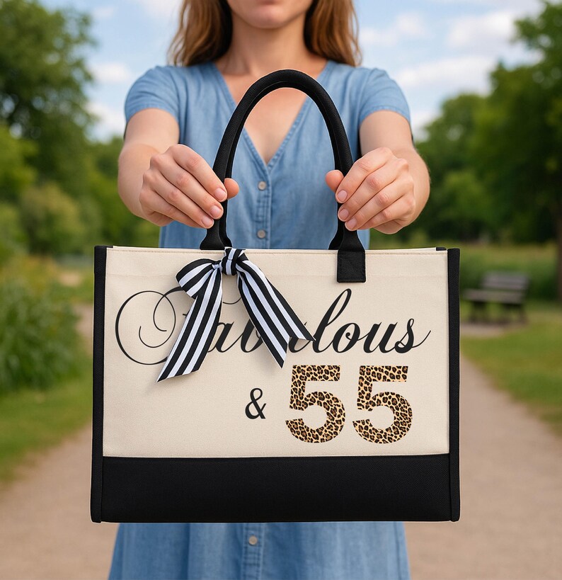 A woman holding a large tote bag with the text "Fantastic & 55" printed on it.