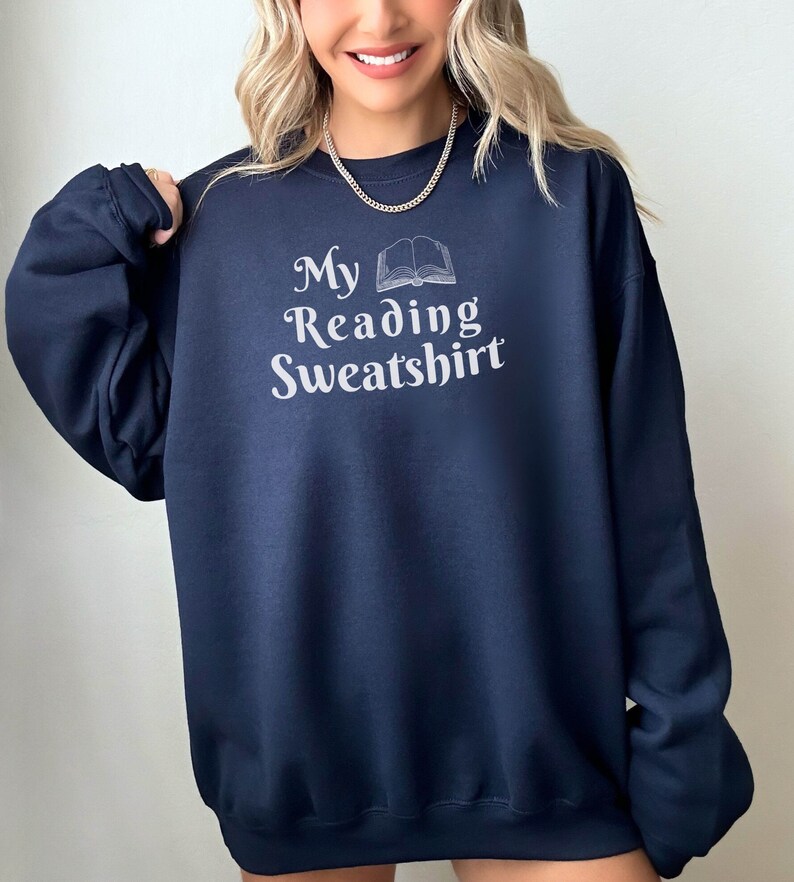 May include: A navy blue sweatshirt with the text "My Reading Sweatshirt" and a graphic of an open book.