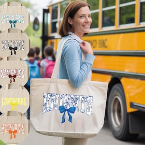 A woman is standing in front of a yellow school bus, smiling and holding a large tote bag with the word "KNIGHTS" printed on it.
