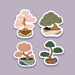 4 different mini bonsai stickers in various designs. One Bonsai is a tall pink trey with heart accents. The second bonsai is a shorter, tree with green leaves. Third bonsai dusty rose colo. The fourth bonsai is skinner with dark green leaves.