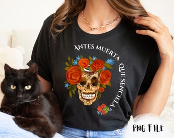 May include: Black t-shirt with a colorful sugar skull design and the text "Antes Muerta Que Sencilla".