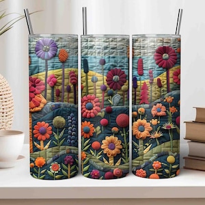 Könnte beinhalten: Drei Edelstahlbecher mit farbenfrohen Blumendesigns. Die Designs zeigen eine Vielzahl von Blumen und Blättern in Rot-, Orange-, Gelb-, Blau- und Grüntönen. Die Becher sind perfekt, um Ihre Lieblingsgetränke zu genießen.