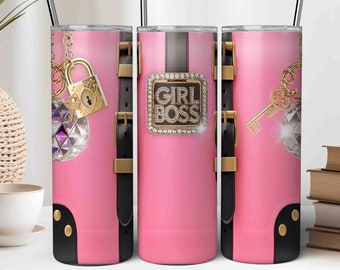 May include: Three pink stainless steel tumblers with black accents and gold accents. The tumblers feature different designs: a padlock and a diamond, a belt buckle with the text "Girl Boss", and a key and a diamond.