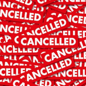 May include: A close-up image of a pile of red paper scraps with the word "CANCELLED" printed in white on each scrap.