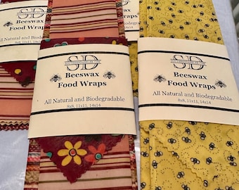 May include: A set of three beeswax food wraps in various patterns. The wraps are all natural and biodegradable. The wraps are available in three sizes: 8x8 inches, 11x11 inches, and 14x14 inches.