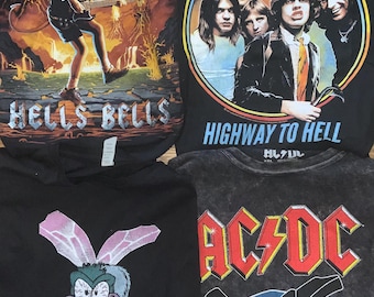 May include: Four black graphic t-shirts featuring the band AC/DC. Designs include the band's logo, the phrases "Hells Bells" and "Highway to Hell", and a cartoon fly with the text "Fly on the Wall".