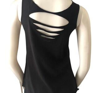 May include: Black tank top with a unique back design. The back of the top features several horizontal cut-out slits, adding a stylish and edgy detail. The sleeveless design and round neckline offer a classic silhouette.