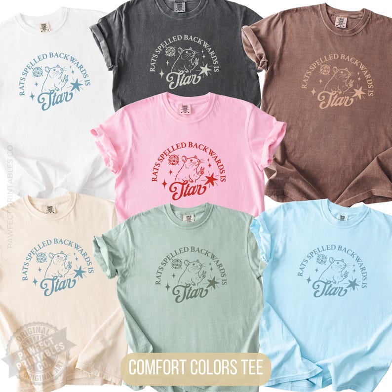 May include: A collection of Comfort Colors t-shirts in various colors, each featuring a graphic with the text "Rats Spelled Backwards Is Tiar" and a rat illustration. The shirts are available in white, gray, pink, brown, beige, green, and light blue.
