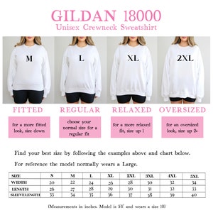 May include: Size chart for Gildan 18000 unisex crewneck sweatshirts. The chart shows measurements in inches for width, length, and sleeve length for sizes S through 5XL. The model is 5'8" and wears a size 10.