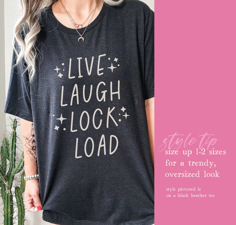 May include: Black t-shirt with white text that reads "LIVE LAUGH LOCK LOAD" with stars around the words. Style tip: size up 1-2 sizes for a trendy, oversized look. Style pictured is on a black heather tee.