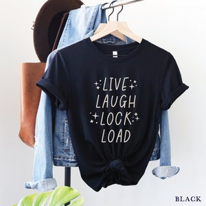 May include: Black t-shirt with the text "LIVE LAUGH LOCK LOAD" in white with small stars around the words.