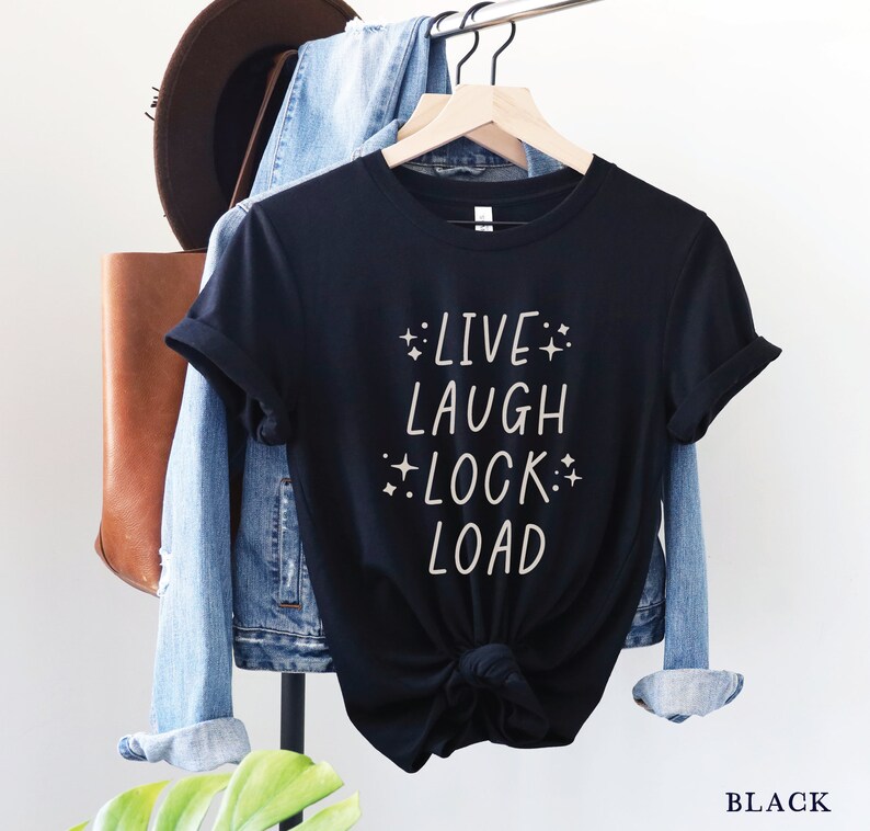 May include: Black t-shirt with the text "LIVE LAUGH LOCK LOAD" in white with small stars around the words.