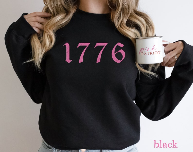 May include: Black sweatshirt with a pink 1776 graphic and the text "pink patriot" on a white mug.