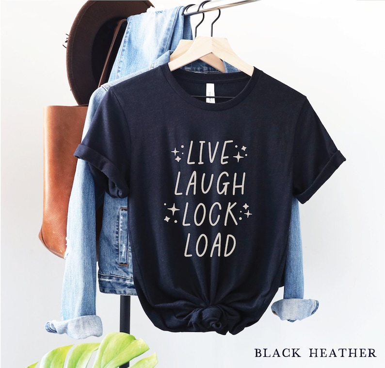 May include: Black heather t-shirt with the text "Live Laugh Lock Load" in white lettering.