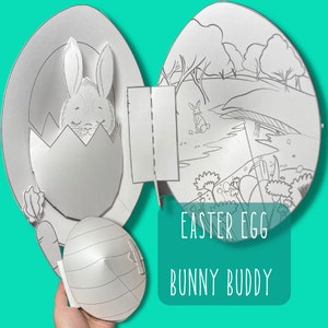 Könnte beinhalten: Ein druckbares Osterbastelset für Kinder mit einem Hasen im Ei, einer Karotte und einer Szene mit einem Hasen auf einem Feld. Der Titel "Easter Egg Bunny Buddy" ist auf dem Bastelset gedruckt.