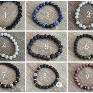 May include: Nine different bracelets featuring a variety of beads and charms. The bracelets are made from lava rock, white beads, blue beads, and pink beads. Some of the bracelets have gold charms, such as skulls, a tree, and a square.
