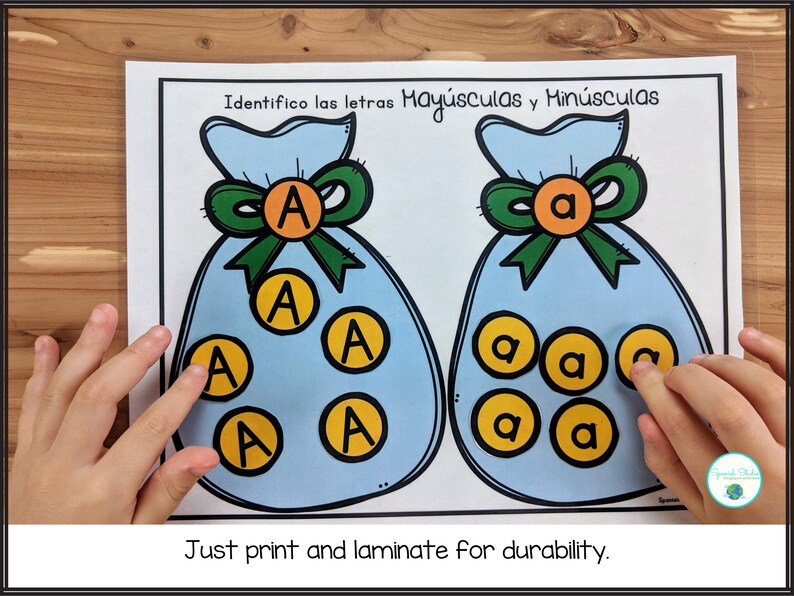 May include: A printable worksheet with two blue bags, one with the letter "A" in uppercase and the other with the letter "a" in lowercase. The bags are filled with yellow circles, each containing a letter "A" or "a". The text "Identifico las letras May&uacute;sculas y Min&uacute;sculas" is at the top of the worksheet. The text "Just print and laminate for durability." is at the bottom of the worksheet.